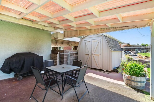 view of patio with a grill, an outdoor structure, and a shed