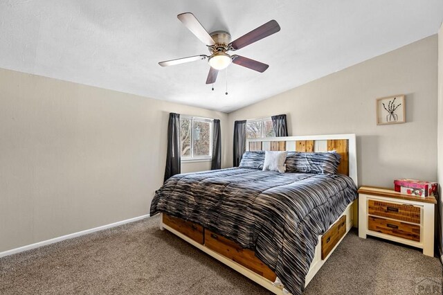 bedroom with lofted ceiling, dark carpet, a ceiling fan, and baseboards