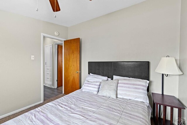 bedroom featuring ceiling fan, dark colored carpet, and baseboards