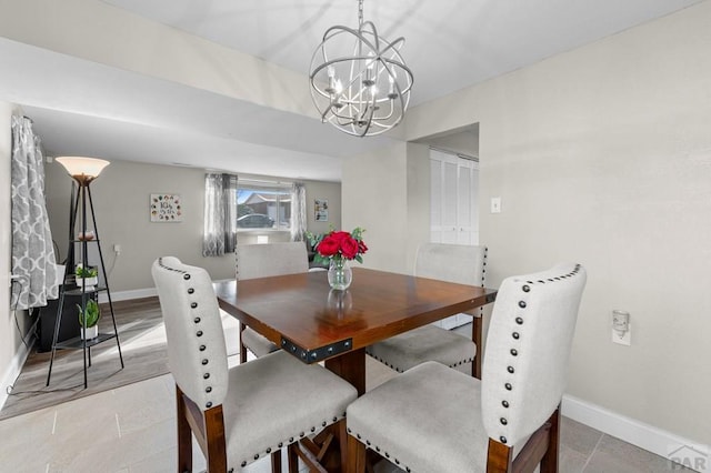 dining room with an inviting chandelier and baseboards