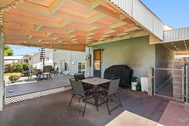 view of patio with outdoor dining area, grilling area, and a wooden deck