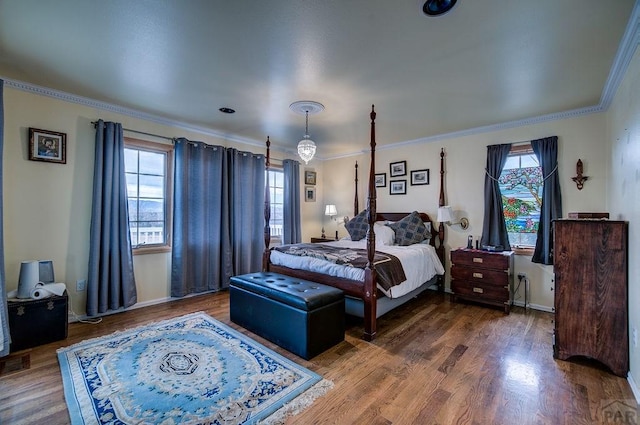 bedroom featuring ornamental molding, baseboards, and wood finished floors