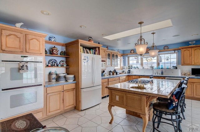 kitchen with a center island, open shelves, glass insert cabinets, light tile patterned flooring, and white appliances