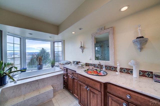 bathroom with recessed lighting, a garden tub, vanity, and a shower stall