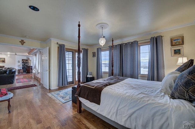 bedroom featuring wood finished floors and crown molding