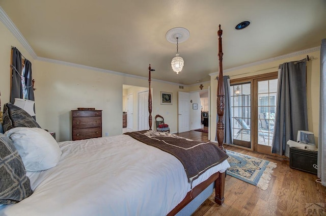 bedroom with visible vents, ornamental molding, and wood finished floors