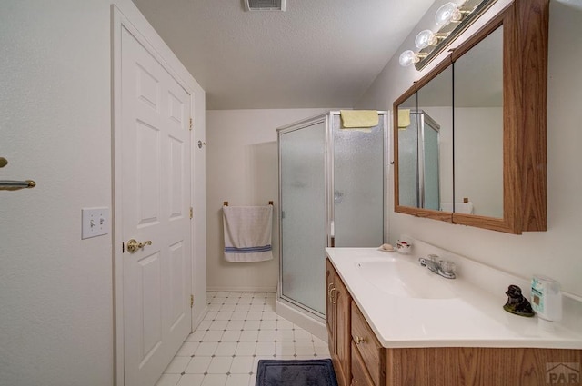 full bathroom featuring visible vents, a shower stall, vanity, and tile patterned floors