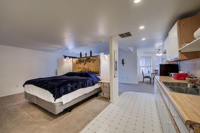 bedroom featuring recessed lighting, light colored carpet, visible vents, a sink, and baseboards