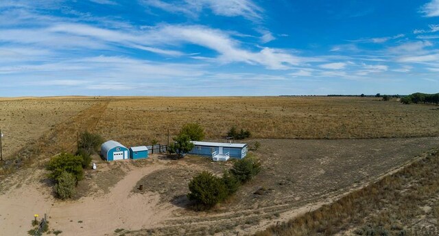 birds eye view of property with a rural view