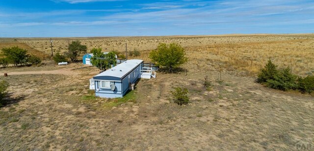 birds eye view of property with a rural view