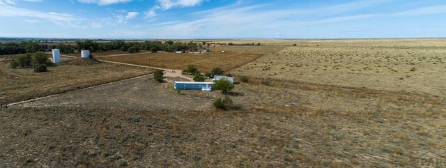 birds eye view of property with a rural view