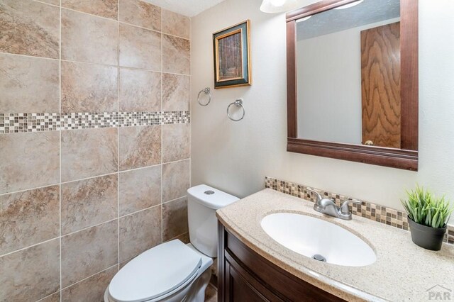 half bath with vanity and toilet