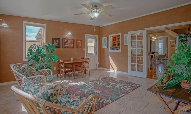 tiled dining space featuring ceiling fan, baseboards, and french doors
