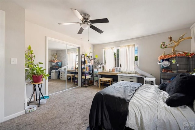 carpeted bedroom featuring ceiling fan and a closet