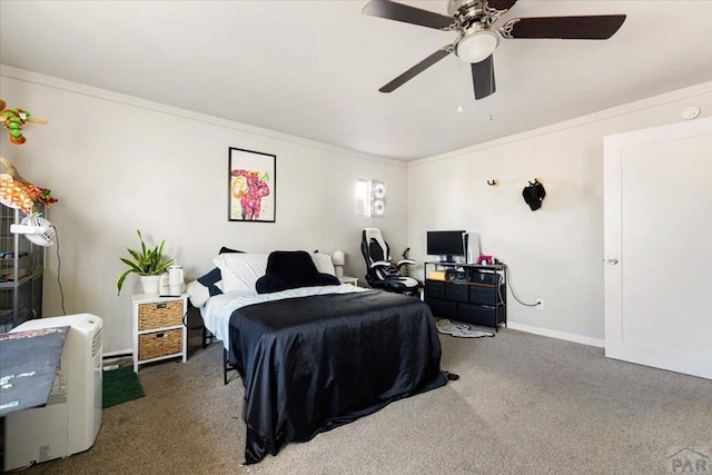 bedroom featuring a ceiling fan, baseboards, carpet floors, and ornamental molding