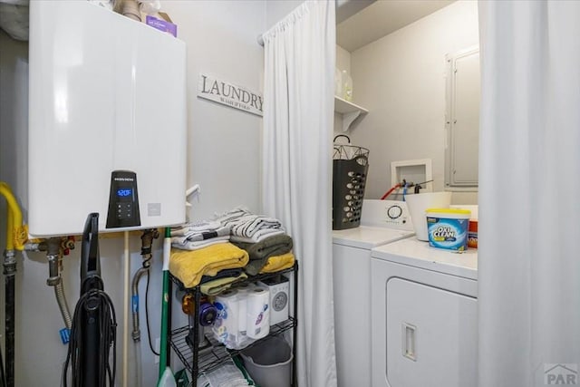 laundry room with water heater and washer and dryer