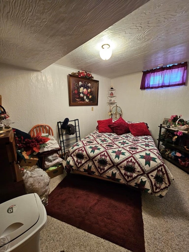 bedroom featuring carpet flooring, a textured wall, and a textured ceiling