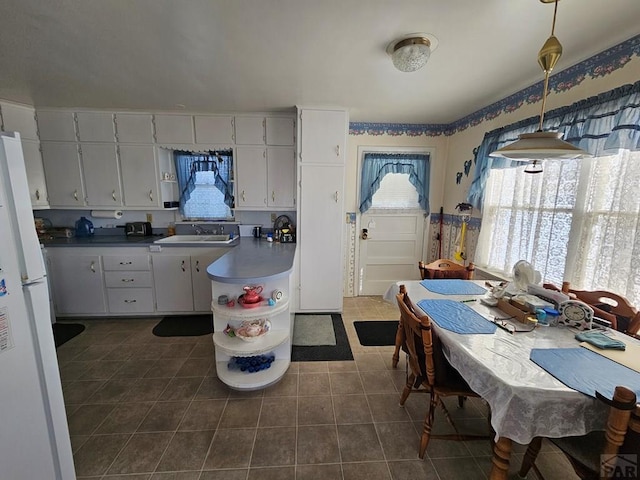 dining room with dark tile patterned floors