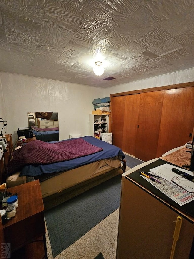 carpeted bedroom featuring an ornate ceiling