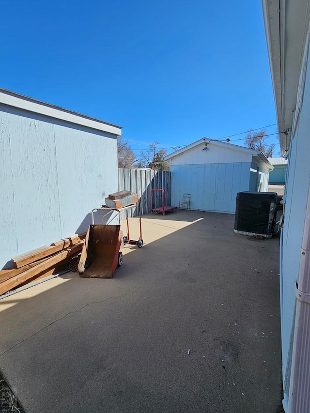 view of patio with central air condition unit and fence