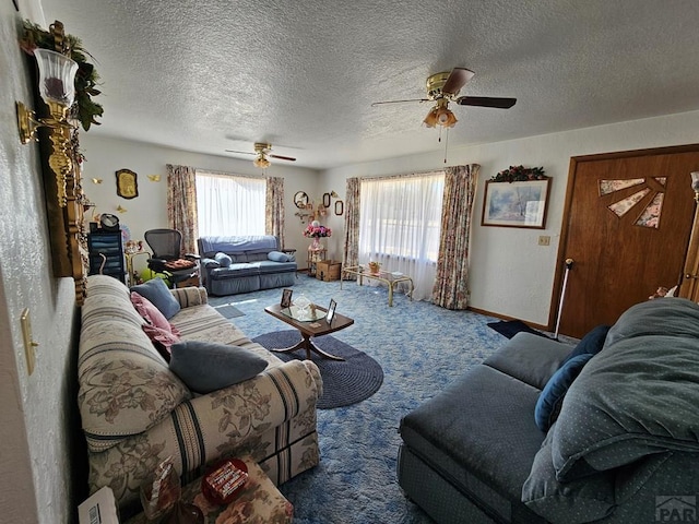 carpeted living room featuring a textured ceiling, baseboards, and ceiling fan