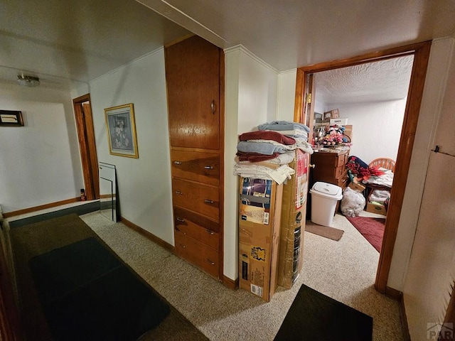 corridor with carpet flooring and baseboards