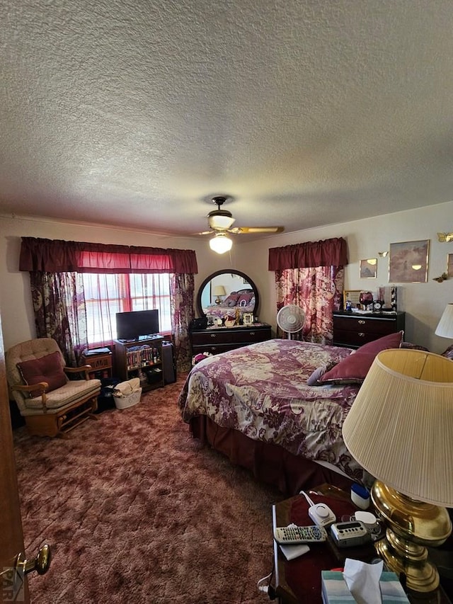 bedroom featuring carpet flooring, a ceiling fan, and a textured ceiling