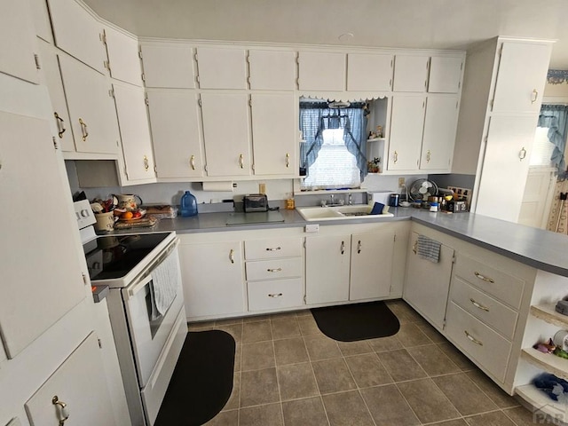 kitchen with a sink, dark tile patterned floors, electric range, white cabinets, and open shelves