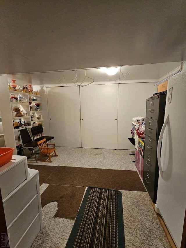 below grade area with freestanding refrigerator