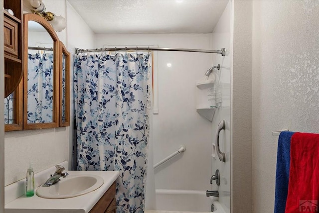 bathroom featuring shower / bath combo and vanity