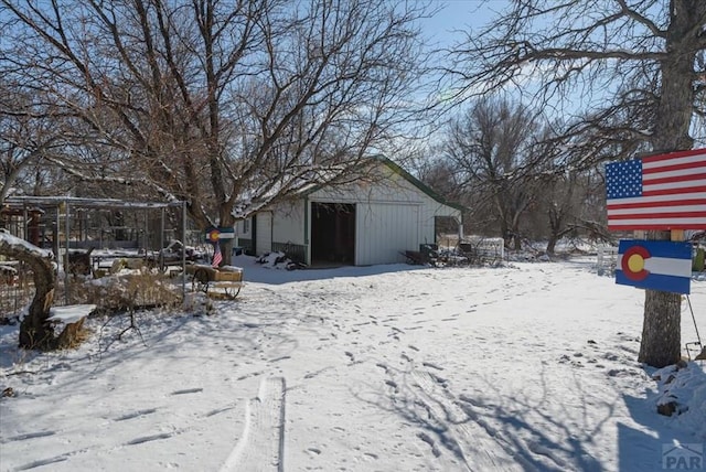 yard layered in snow with a detached garage