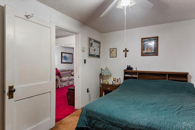 bedroom with carpet floors, ceiling fan, and a textured ceiling