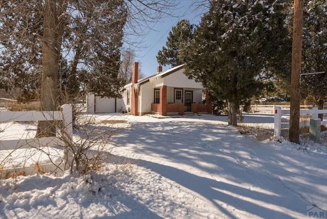 view of front of house with brick siding, fence, and an attached garage