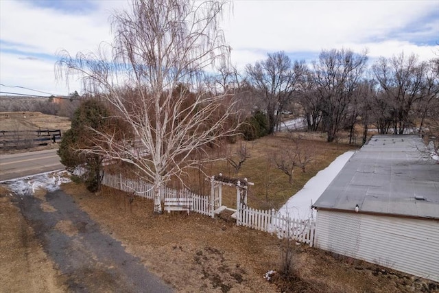 view of yard with a rural view and fence