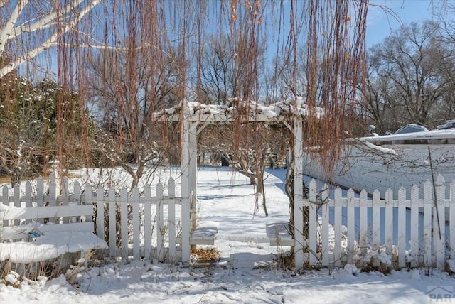 snowy yard with fence