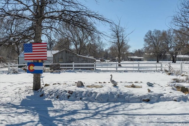 yard covered in snow with fence