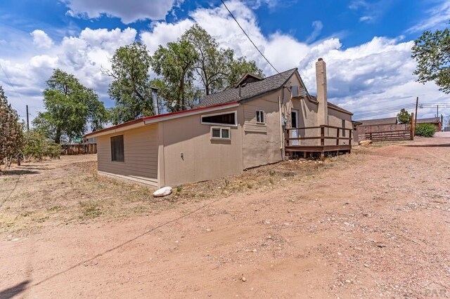 view of side of property featuring a deck