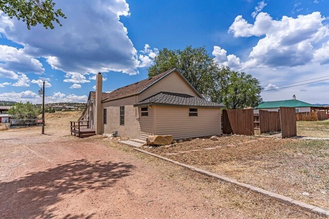 view of home's exterior with fence