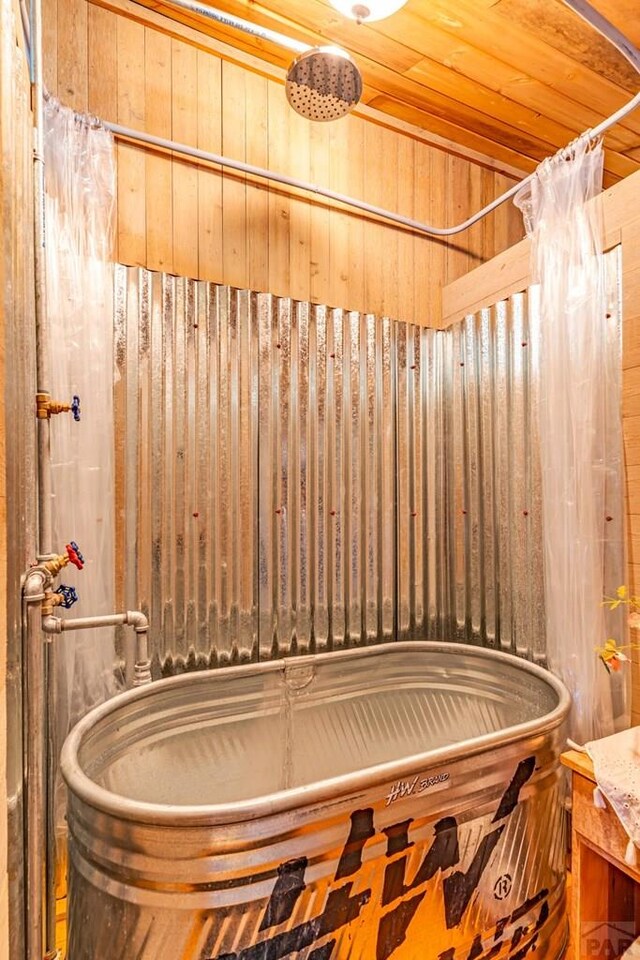 bathroom featuring wooden ceiling and wooden walls