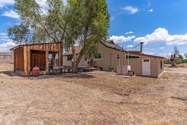 back of house featuring stucco siding