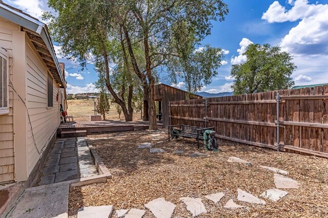 view of yard with fence and a deck