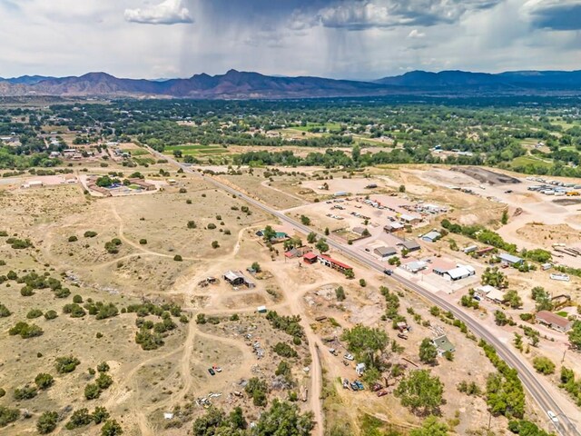 birds eye view of property featuring view of desert and a mountain view