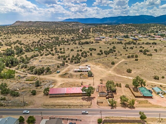 aerial view featuring a desert view and a mountain view