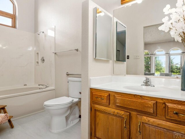 bathroom featuring toilet, tile patterned flooring, a textured ceiling, vanity, and shower / washtub combination