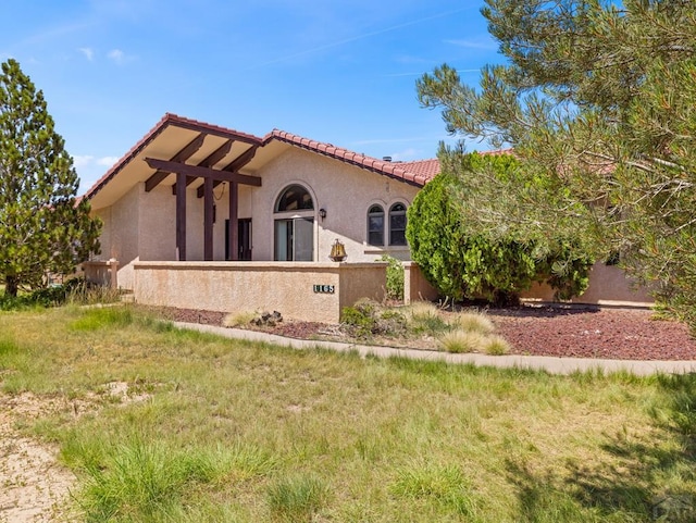 exterior space with a tiled roof and stucco siding