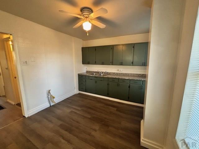 kitchen with a ceiling fan, baseboards, dark wood finished floors, and green cabinets