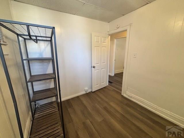 interior space with dark wood finished floors and baseboards