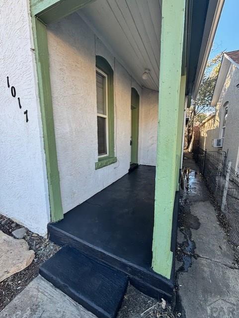 exterior space featuring fence and stucco siding