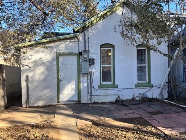 exterior space with a patio area and stucco siding