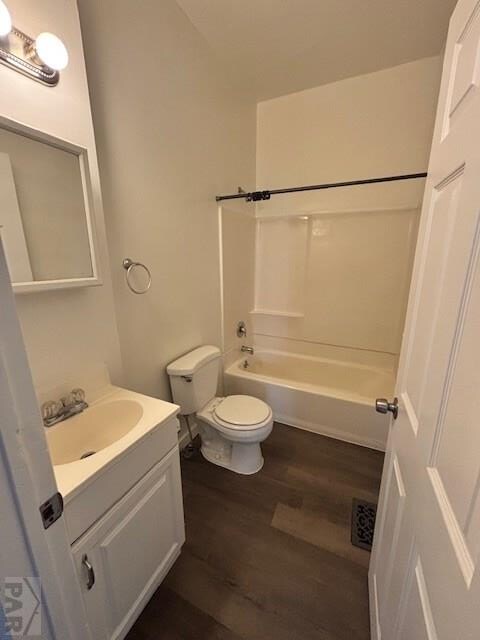 full bathroom with shower / bath combination, toilet, wood finished floors, and vanity